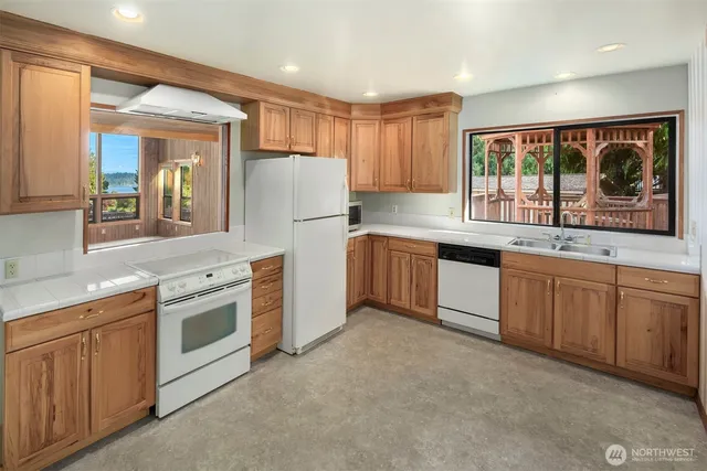 a kitchen with white cabinets and white appliances