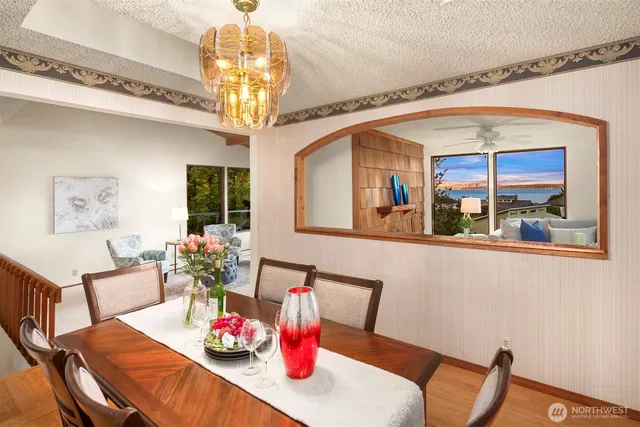 a view of a dining room with furniture a chandelier and wooden floor