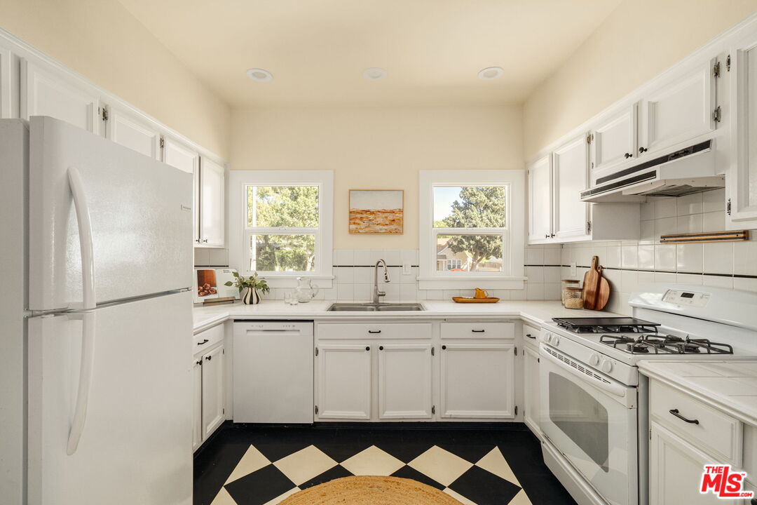 1667 Allen Avenue Pasadena, CA 91104 - Photo 11 of 50 a kitchen with stainless steel appliances a stove a sink and a refrigerator