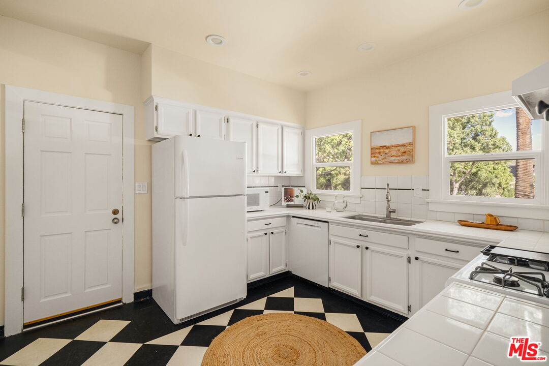 1667 Allen Avenue Pasadena, CA 91104 - Photo 12 of 50 a kitchen with stainless steel appliances a stove a sink and a refrigerator