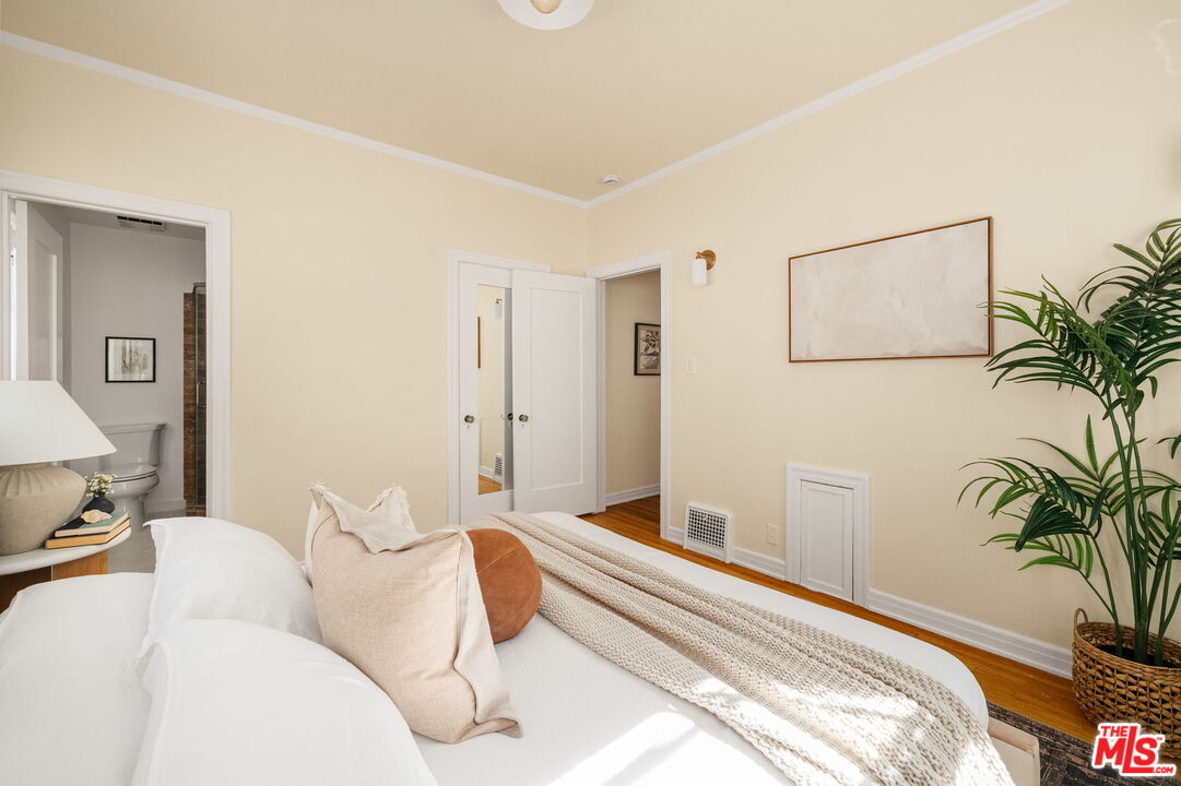 1667 Allen Avenue Pasadena, CA 91104 - Photo 15 of 50 a bedroom with a bed and a potted plant