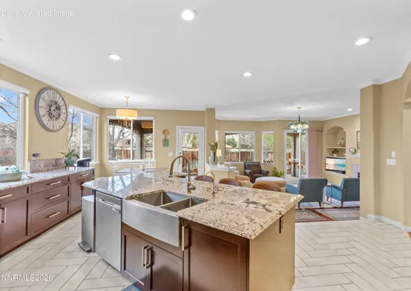 a large kitchen with granite countertop a table and chairs