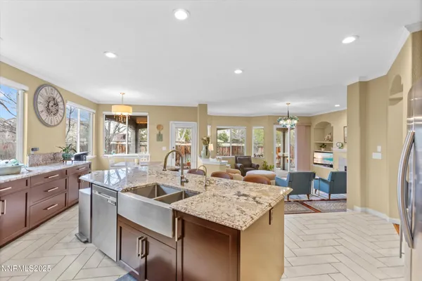 a kitchen with kitchen island granite countertop wooden cabinets a counter top space and stainless steel appliances