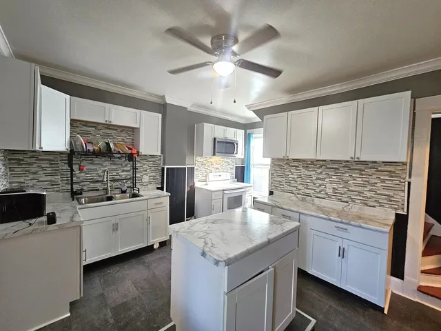 a kitchen with lot of cabinets and refrigerator