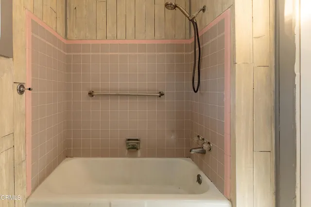a bath tub sitting next to a shower