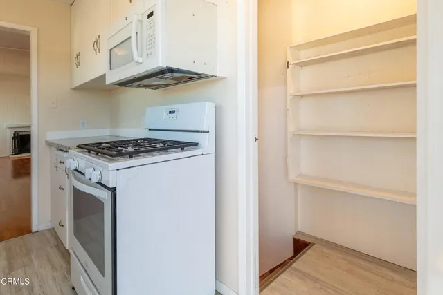 a kitchen with cabinets and appliances