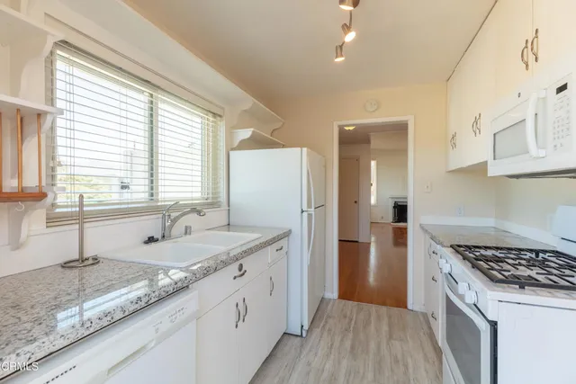 a kitchen with a sink stove and refrigerator