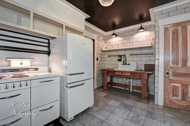 a kitchen with refrigerator and cabinets