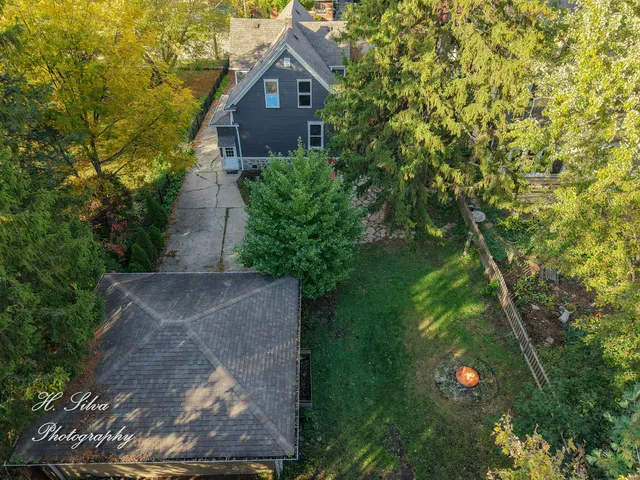 a front view of a house with a yard and garden