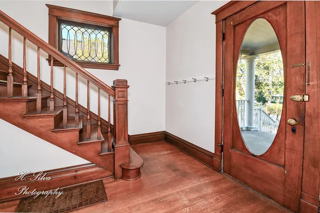 a view of an entryway door with a staircase
