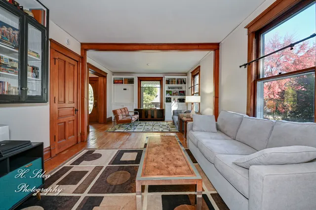 a living room with furniture a rug and a window