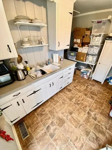 a kitchen with sink stove and cabinets