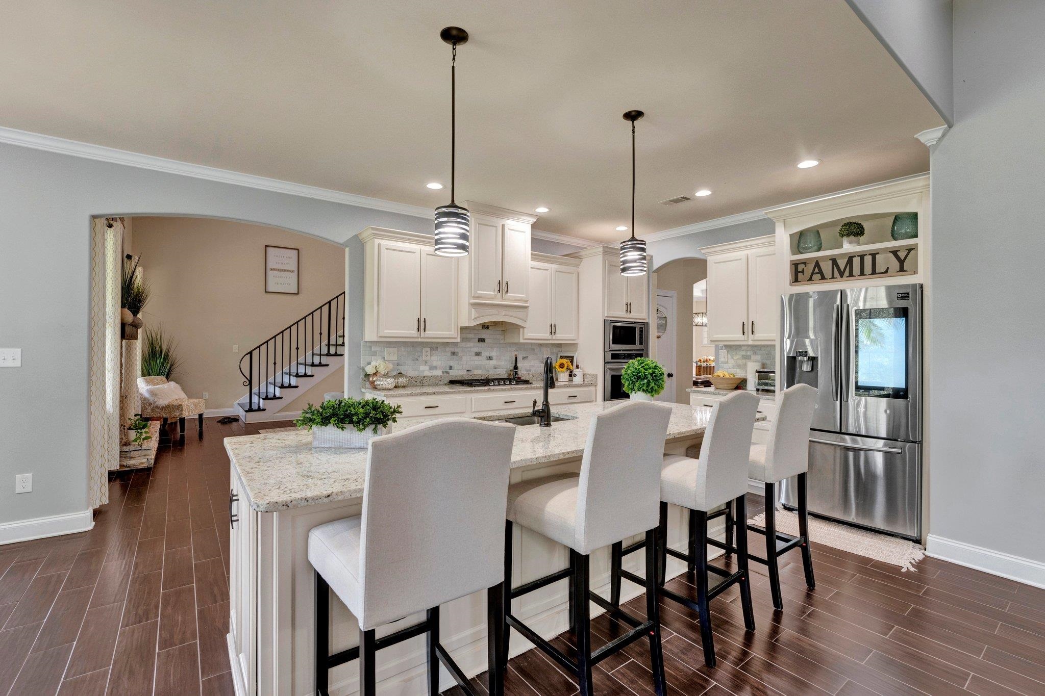 3270 Rast Road Millington, TN 38053 - Photo 11 of 40 Kitchen featuring arched walkways, a kitchen bar, appliances with stainless steel finishes, light stone counters, and hanging light fixtures