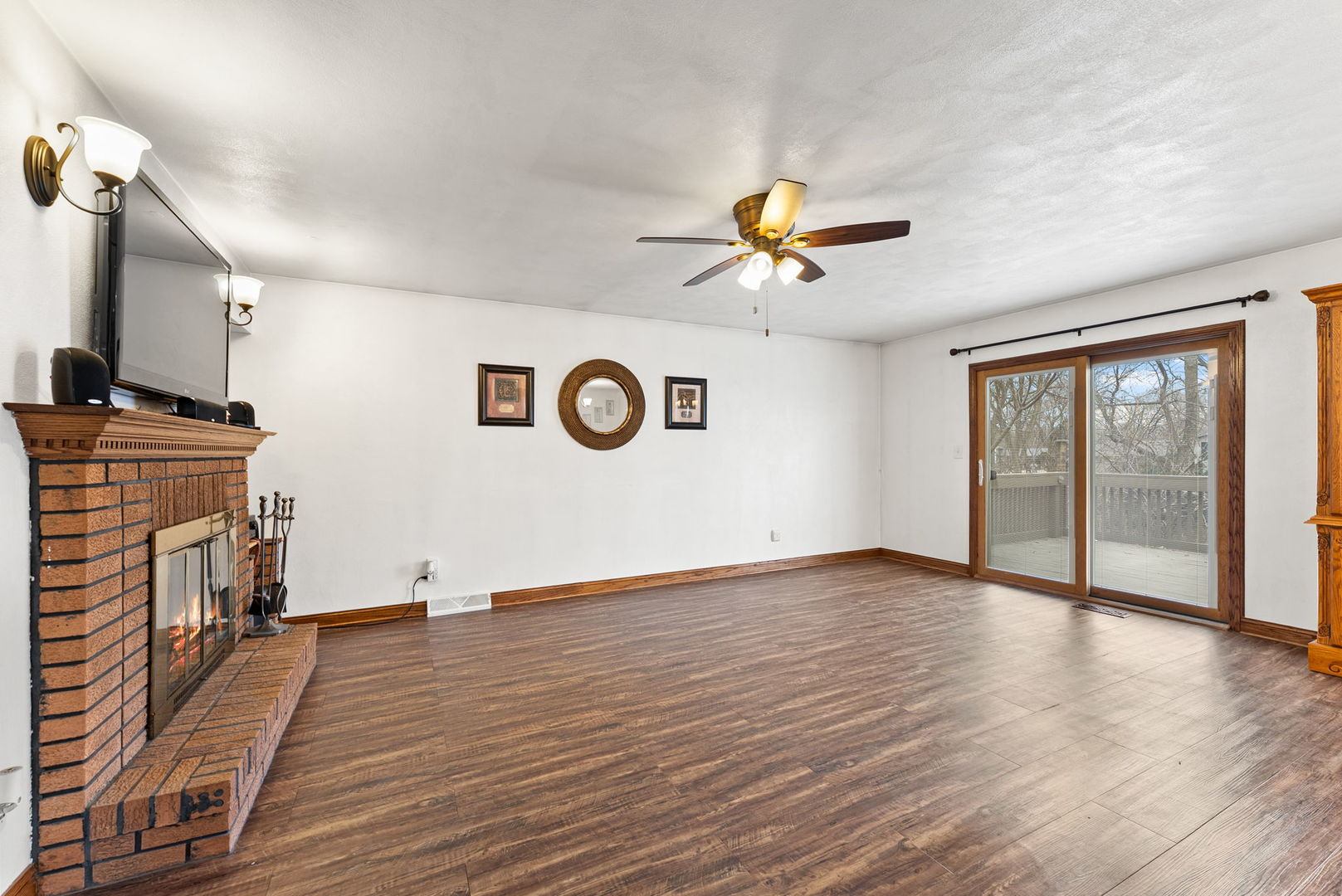 110 Andrea Court Cleveland, IL 61241 - Photo 7 of 23 a view of a livingroom with a fireplace a ceiling fan and wooden floor
