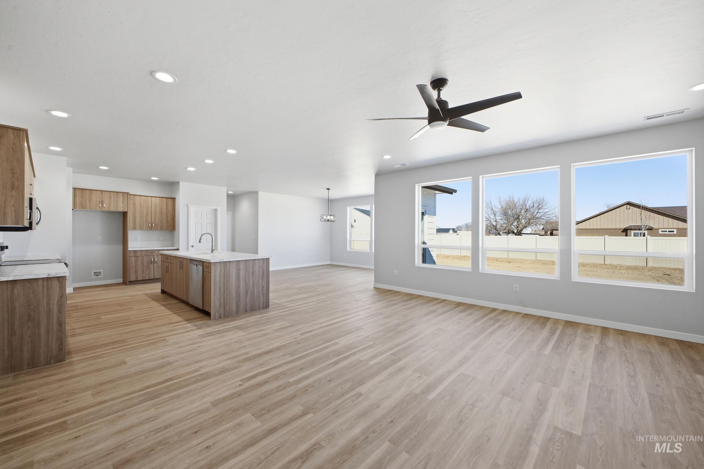 13633 Redway Court Caldwell, ID 83607 - Photo 11 of 29 Unfurnished living room featuring light wood finished floors, a ceiling fan, and recessed lighting