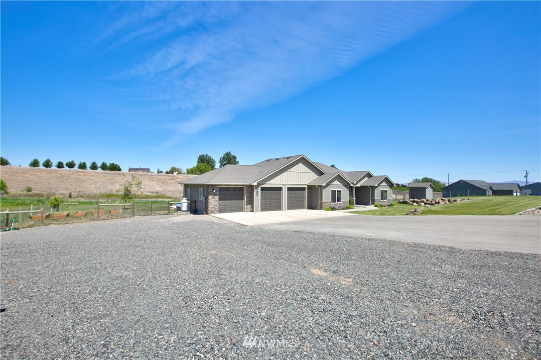 11301 Stump Road Yakima, WA 98908 - Photo 2 of 24 a view of a large house with a big yard and large trees