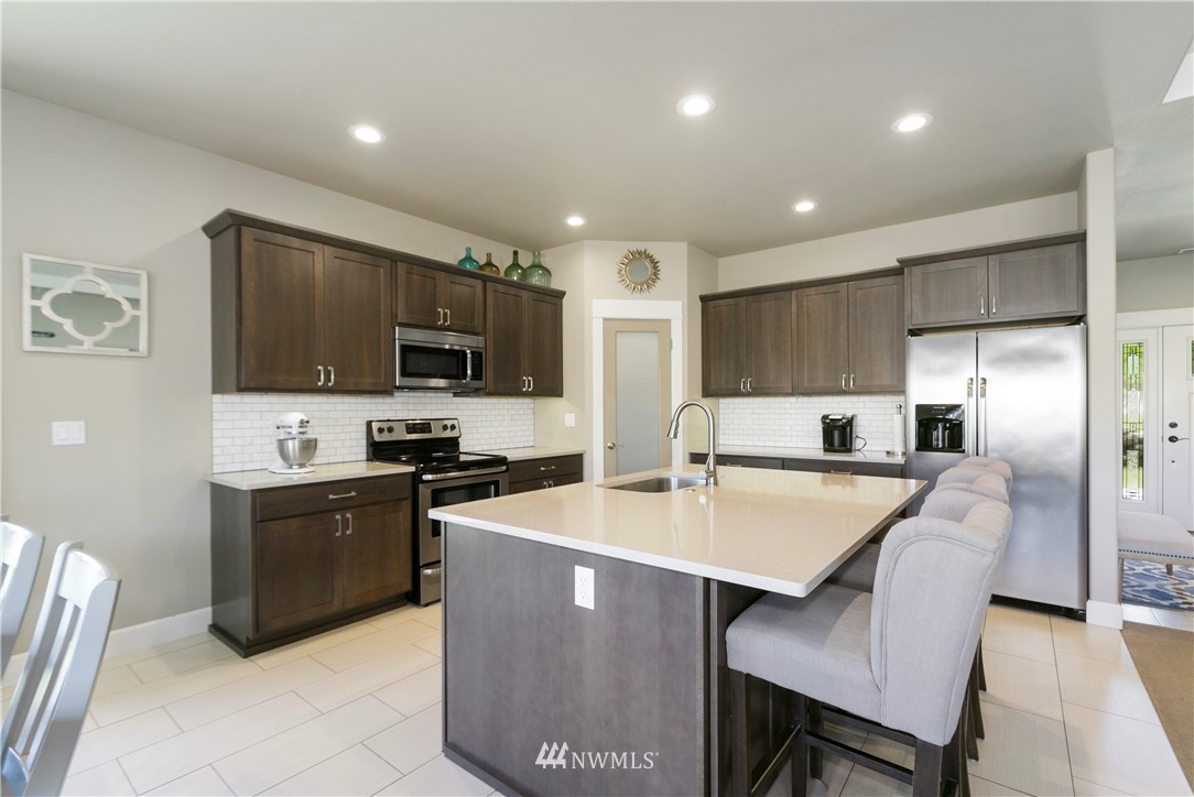 11301 Stump Road Yakima, WA 98908 - Photo 13 of 24 a large kitchen with cabinets table and chairs
