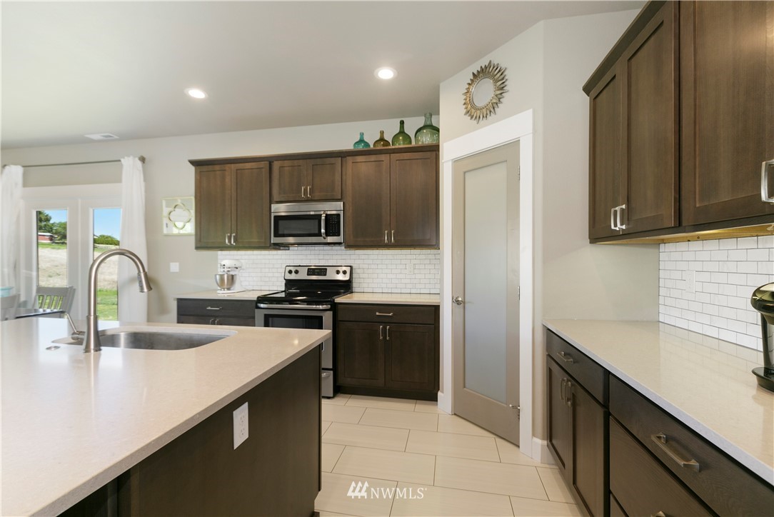 11301 Stump Road Yakima, WA 98908 - Photo 15 of 24 a kitchen with a sink a stove and refrigerator