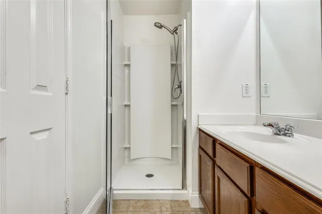 a bathroom with a shower and a sink