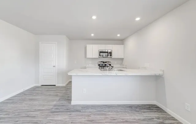a view of a sink and cabinet with wooden floor