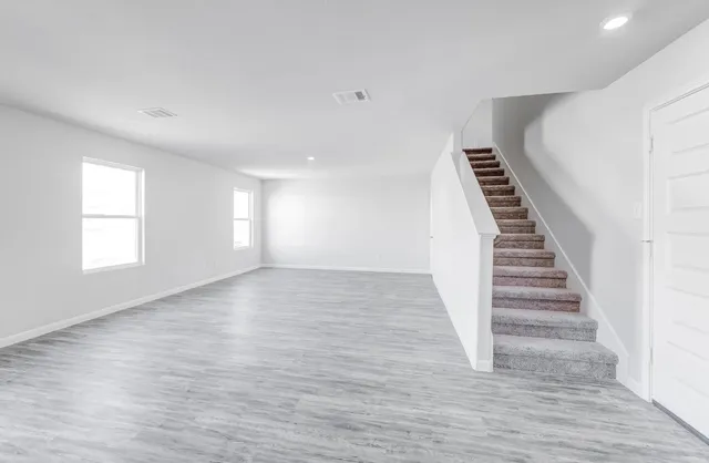 a view of wooden floor and windows in a room