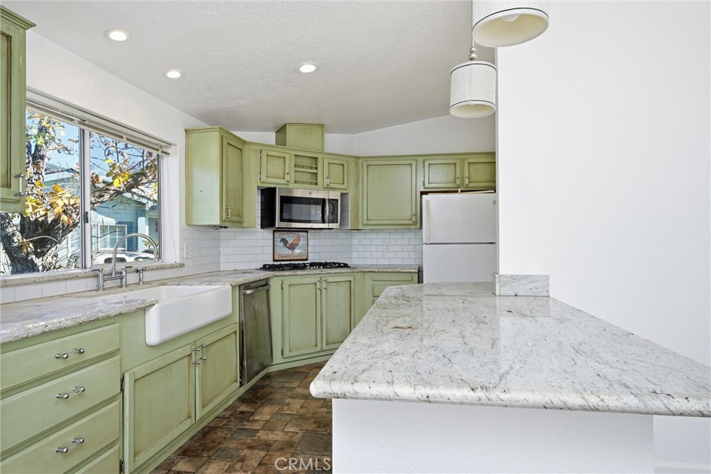 6763 Collier Avenue, Unit 10 Upper Lake, CA 95485 - Photo 12 of 35 a kitchen with sink a microwave and cabinets