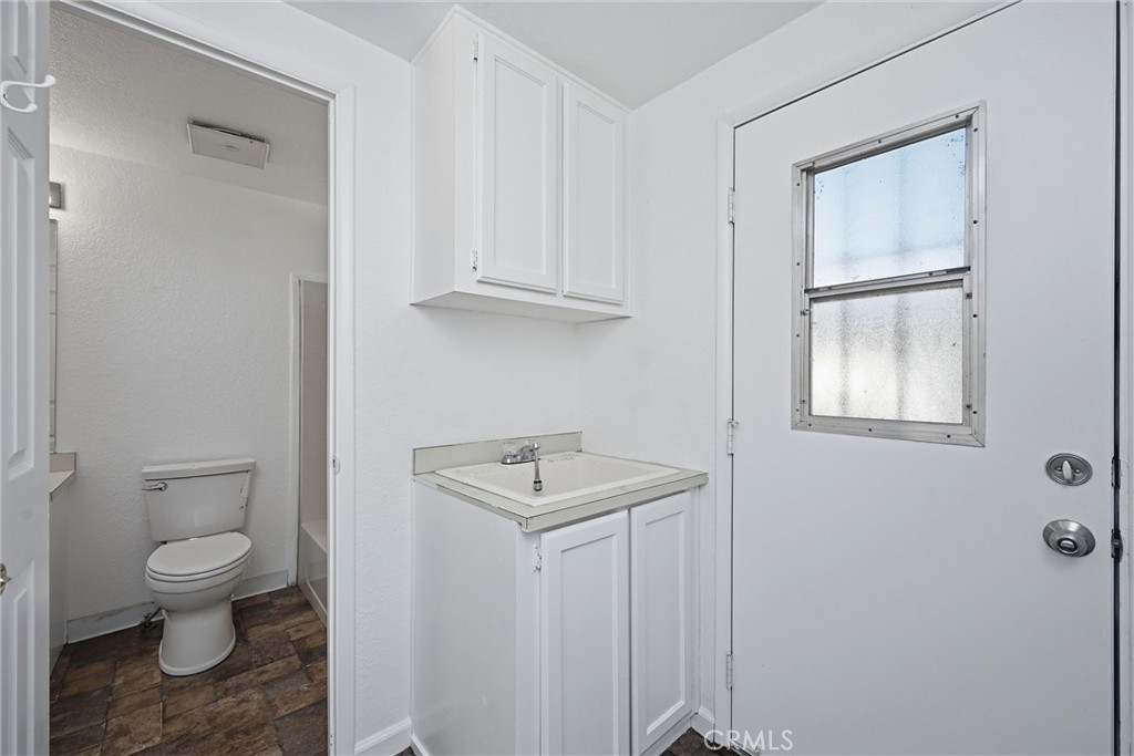 6763 Collier Avenue, Unit 10 Upper Lake, CA 95485 - Photo 14 of 35 a bathroom with a toilet a sink and a window