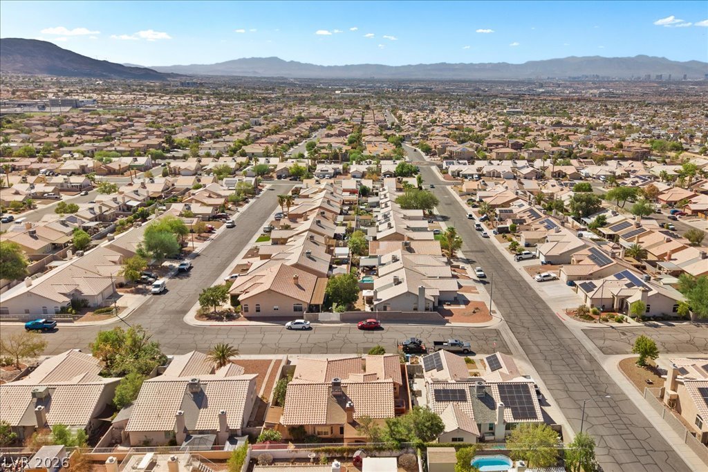 120 Ringlore Road Henderson, NV 89015 - Photo 56 of 58 Distant mountains frame a sprawling suburban neighborhood of tile-roof homes.