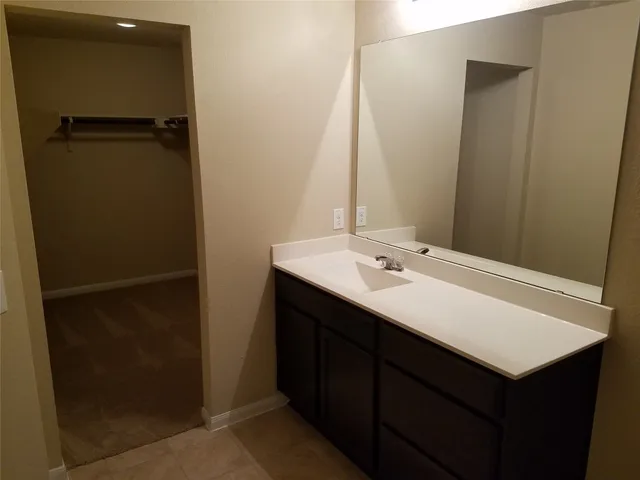a bathroom with a glass shower door