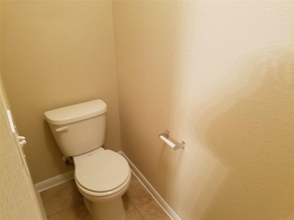 5905 Montrelia Drive Austin, TX 78724 - Photo 14 of 25 a white toilet sitting next to a white wall