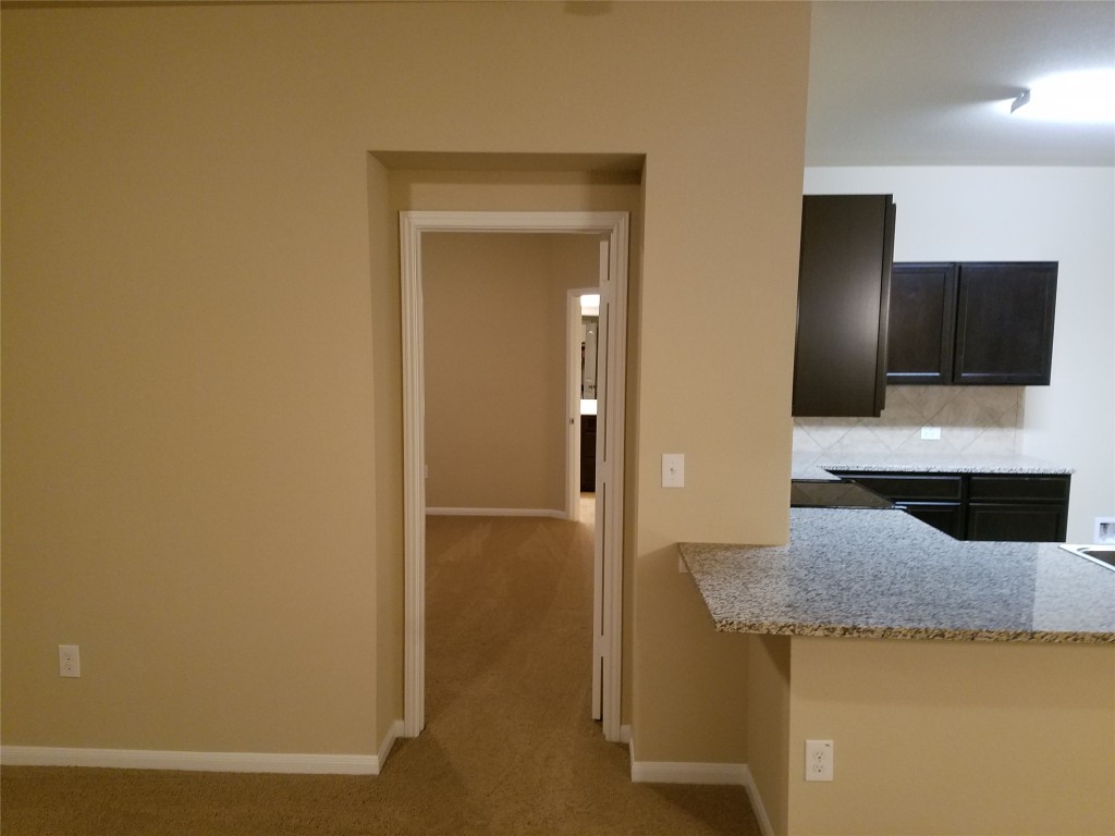 5905 Montrelia Drive Austin, TX 78724 - Photo 8 of 25 a bathroom with a granite countertop sink and a mirror