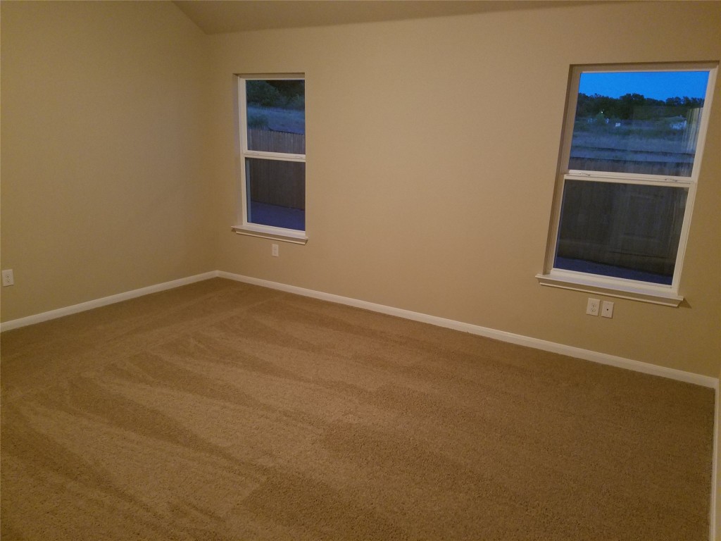 5905 Montrelia Drive Austin, TX 78724 - Photo 10 of 25 a view of an empty room with a fireplace and a window