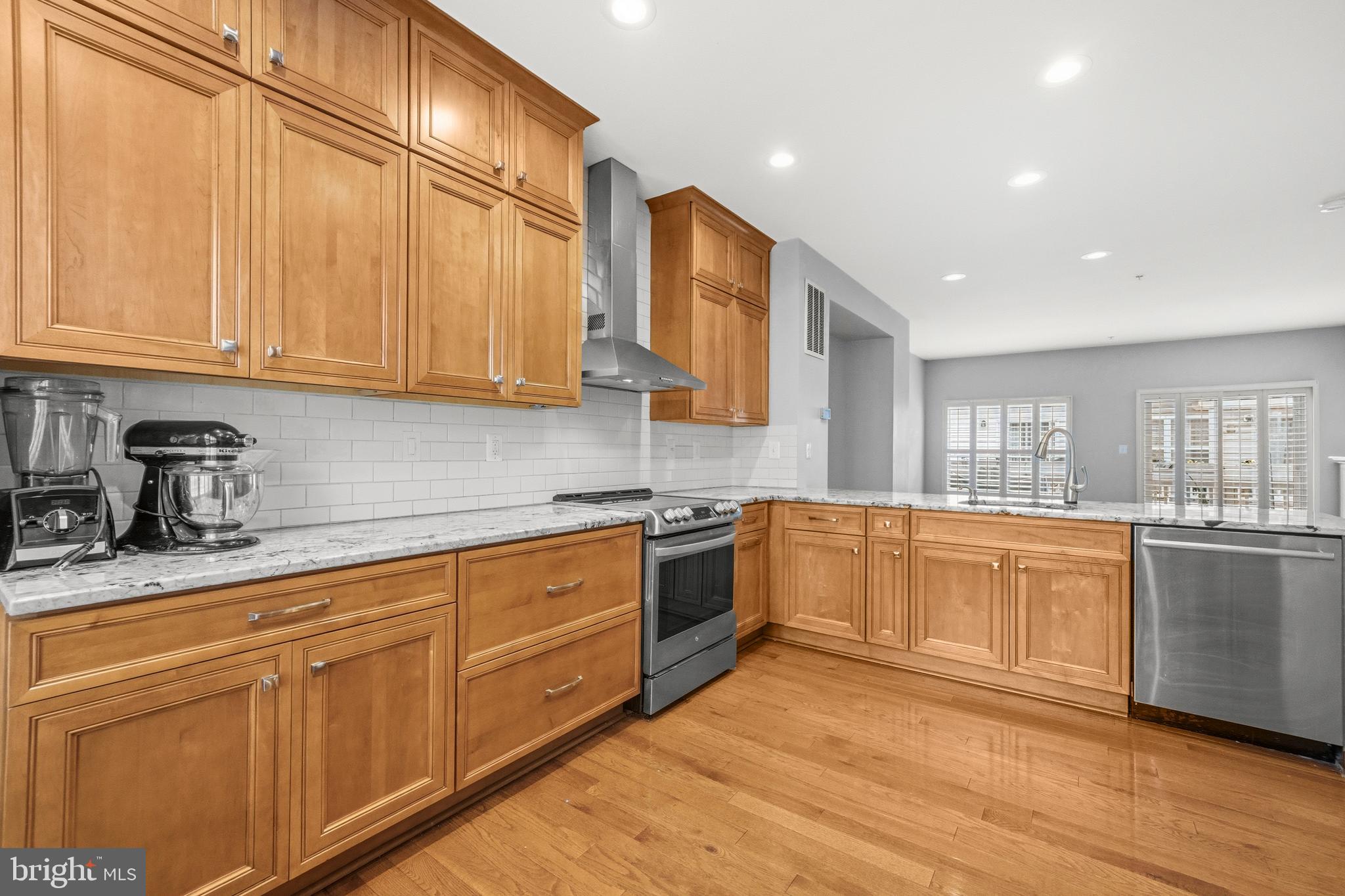 2116 12th Street Northwest Washington, DC 20009 - Photo 11 of 35 a kitchen with stainless steel appliances granite countertop a sink and cabinets