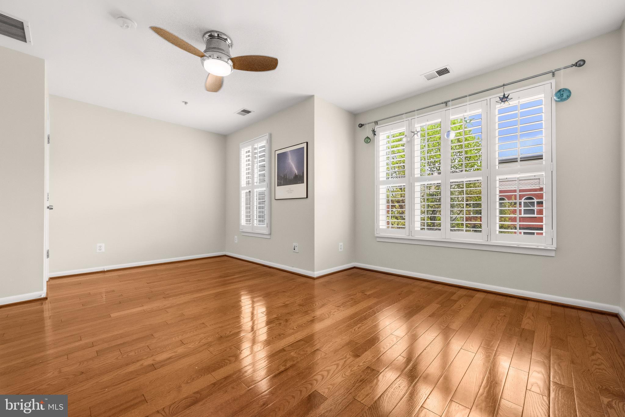 2116 12th Street Northwest Washington, DC 20009 - Photo 15 of 35 a view of an empty room with a window and wooden floor