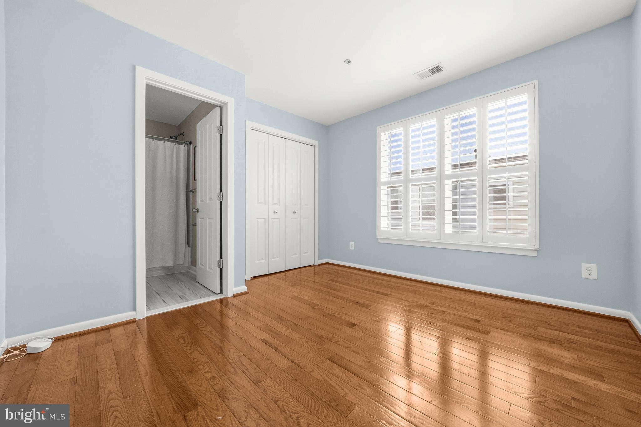 2116 12th Street Northwest Washington, DC 20009 - Photo 20 of 35 a view of an empty room with wooden floor and a window