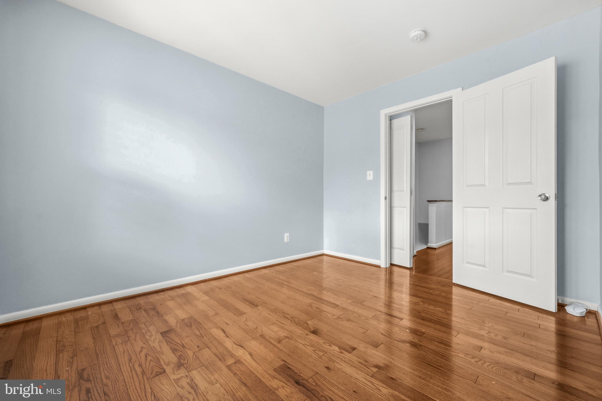 2116 12th Street Northwest Washington, DC 20009 - Photo 21 of 35 a view of an empty room with wooden floor and a window