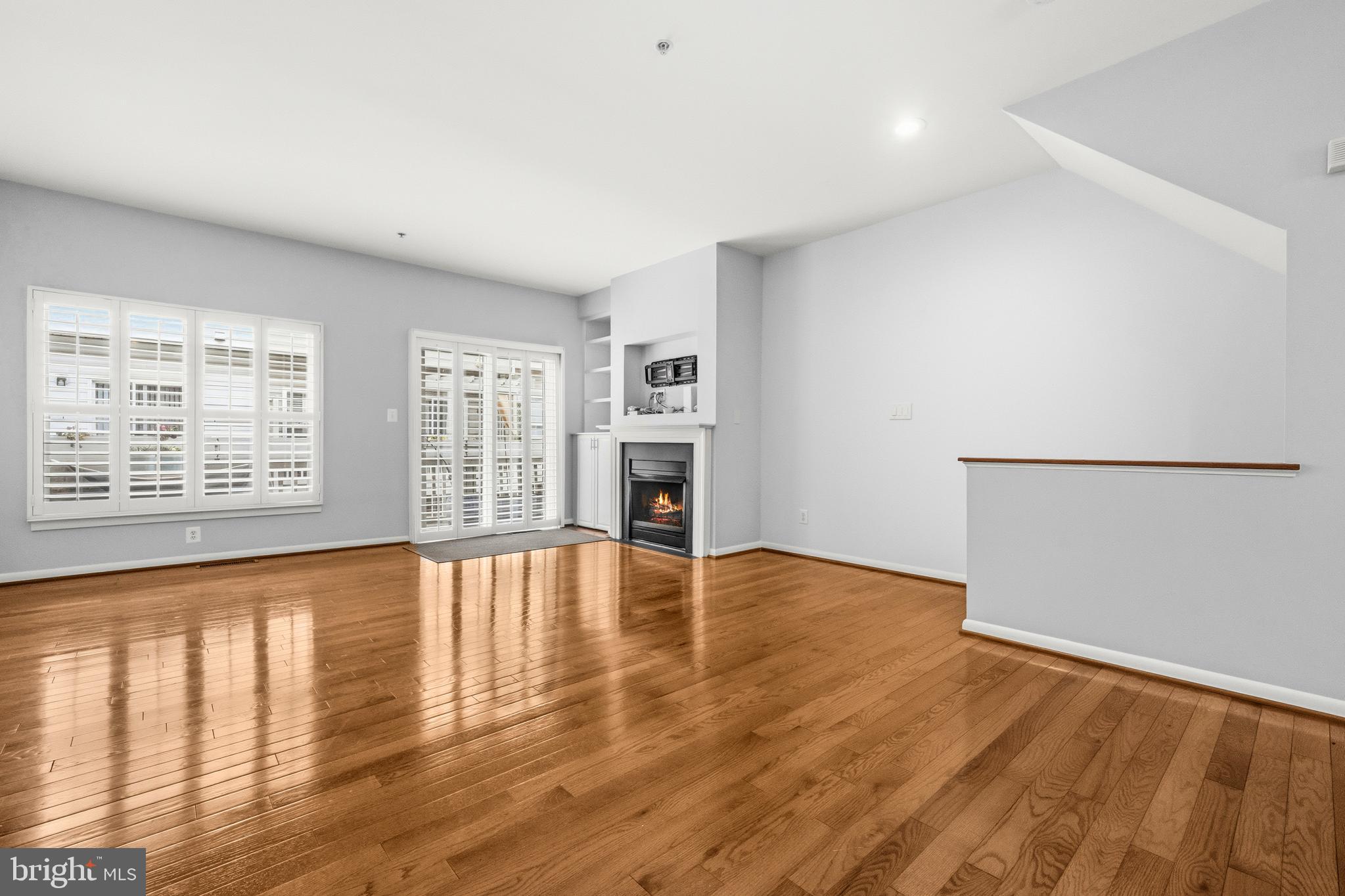 2116 12th Street Northwest Washington, DC 20009 - Photo 8 of 35 a view of an empty room with wooden floor and a window