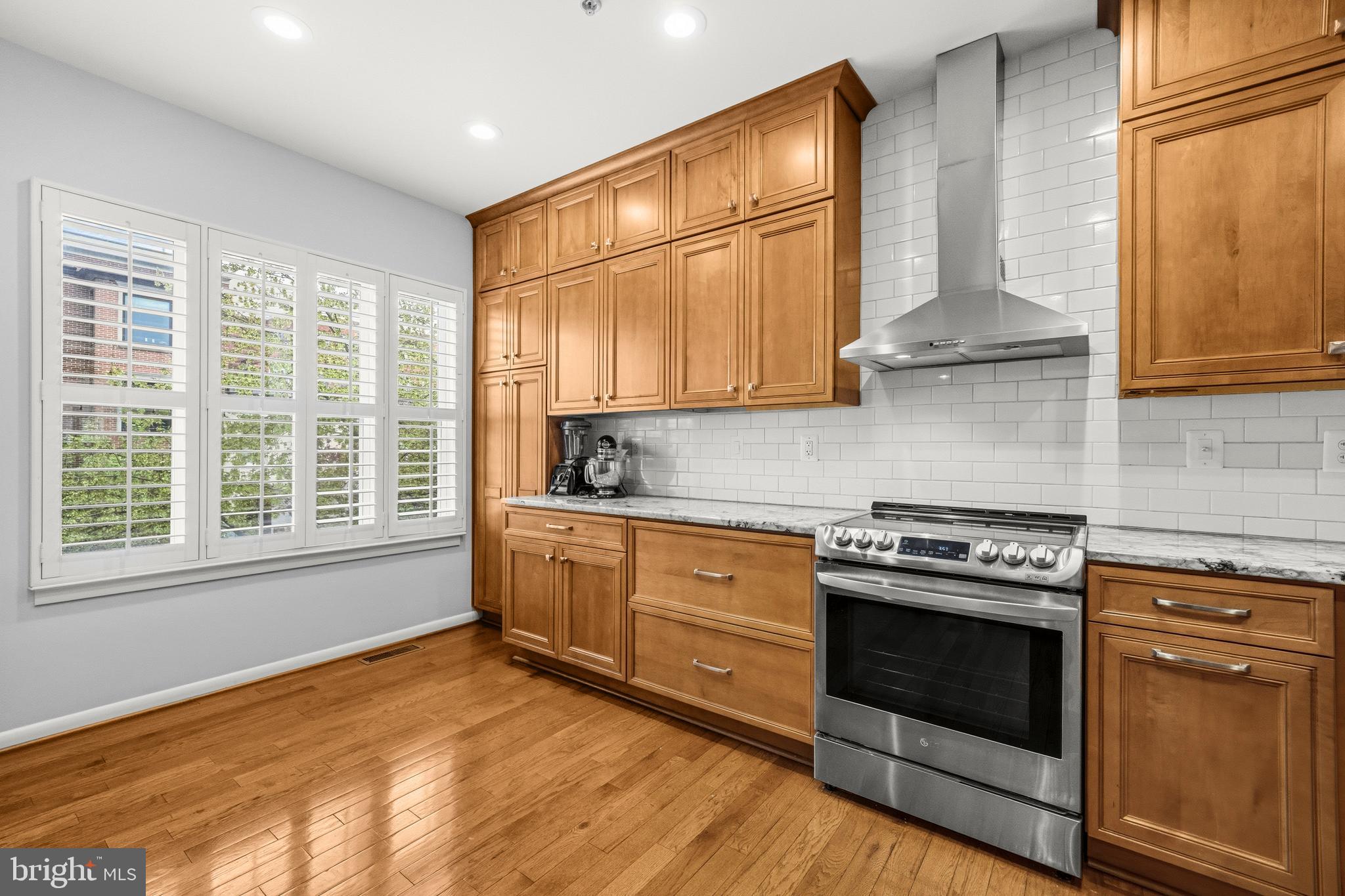 2116 12th Street Northwest Washington, DC 20009 - Photo 9 of 35 a kitchen with stainless steel appliances granite countertop a stove a sink and a refrigerator