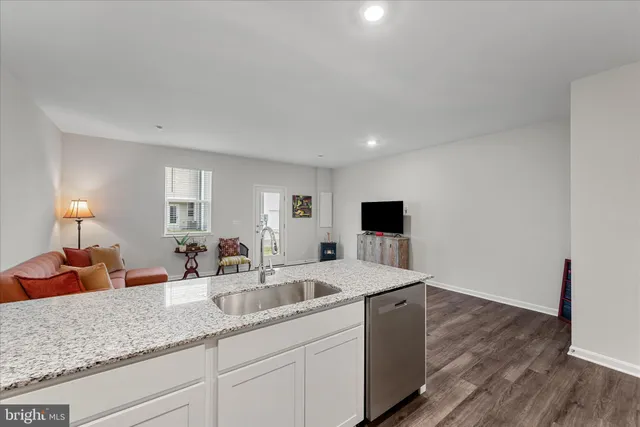 a kitchen with sink and mirror