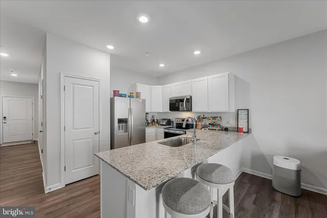 a kitchen with a table chairs stove and refrigerator