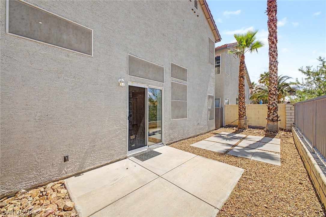 2316 Ramsgate Drive Henderson, NV 89074 - Photo 25 of 28 A private patio space with practical paving stones and natural desert landscaping, ideal for outdoor relaxation.