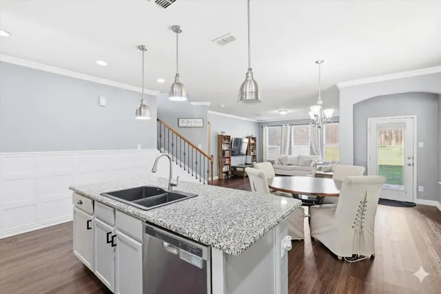 a kitchen with counter space and wooden floor