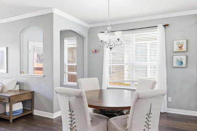 a view of a dining room with furniture and windows