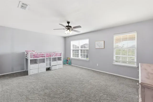 an empty room with furniture and windows