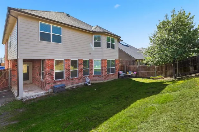a view of a house with a yard and sitting area