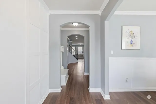 a view of a hallway with wooden floor and staircase