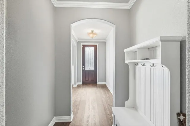 a view of a hallway with wooden floor and closet