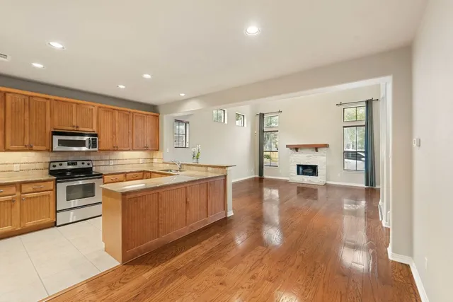 a view of a white house with large windows and a small yard