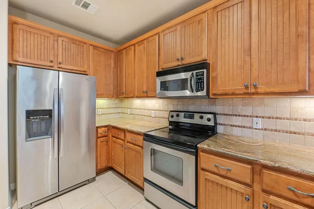 a kitchen with a sink dishwasher and stove