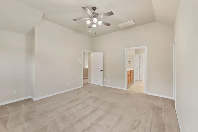 a view of an empty room with a ceiling fan